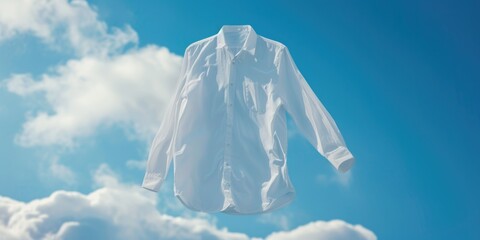 A white shirt is seen hanging from a clothesline against a blue sky backdrop. This image can be used to depict concepts of freshness, cleanliness, laundry, or simplicity - Powered by Adobe