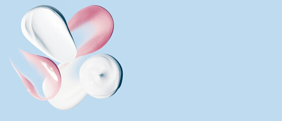 Set of white and pink cream smears on a blue background. empty space