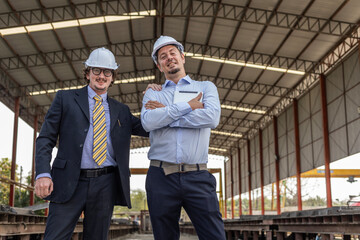 Two civil engineers from different cultures stand with confident for their prefabs business...