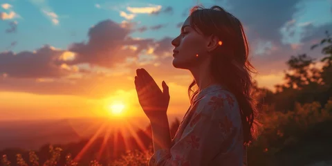 Fotobehang Woman hands praying for blessing from god on sunset background © Muhammad