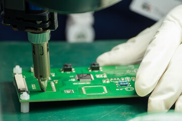 Close up scene the PCB board checking process by operator. © Pixel_B