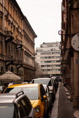 view into the street with buildings and cars