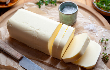 A stick of butter with fresh herbs.