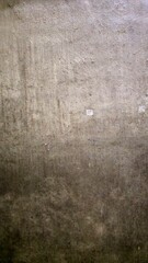 Grungy concrete wall texture with scratched paint.