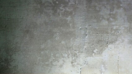 Grungy concrete wall texture with scratched paint.