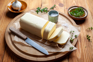 A stick of butter with fresh herbs.