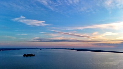 Naklejka premium A drone photo of beautiful blue sunset the Island at Dunedin Causeway, Florida 