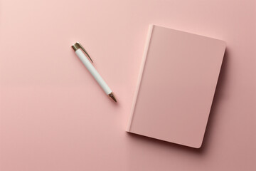  A serene workspace featuring a pink notebook and a silver pen. Ideal for planning, journaling, or...