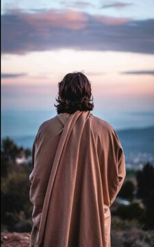 Back view of Jesus looking at the sky