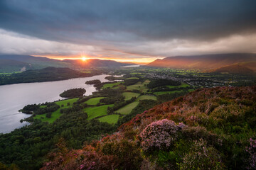 Beautiful sunset over Derwentwater in The Lake District, UK. Seen from Walla Crag with dramatic clouds and golden sunlight.