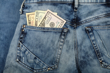 US dollar banknotes in jeans back pocket