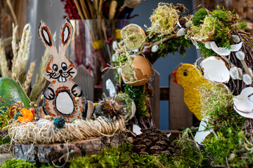 Enchanting Easter Scene: Wooden Rabbit, Colorful Eggs, and Rustic Decor Elements in Soft Pastel Light