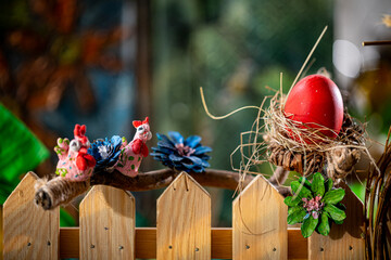 Rustic Easter Composition: Handcrafted Nest, Red Egg, and Whimsical Bird Figures