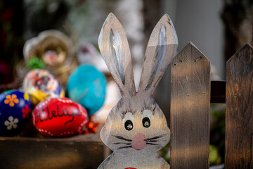 Enchanting Easter Composition: Hand-drawn Rabbit Shape with Vibrant Red Egg Featuring ,Alleluia, Text, Set Against Wooden Fence