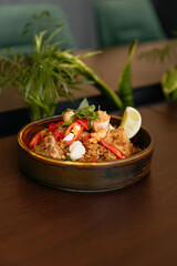 Indian spicy dish on wooden table in restaurant