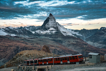 Electric train running on railway through Matterhorn mountain in Gornergrat station