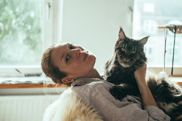 Reflective Woman with Maine Coon Cat
