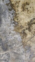 Grungy concrete wall texture with scratched paint.