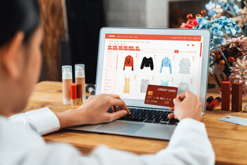 Woman shopping online on internet marketplace browsing for sale items for modern lifestyle and use credit card for online payment from wallet protected by uttermost cyber security software - obrazy, fototapety, plakaty
