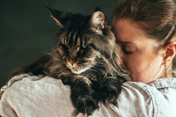 Woman Embracing Pet Cat at Home - obrazy, fototapety, plakaty