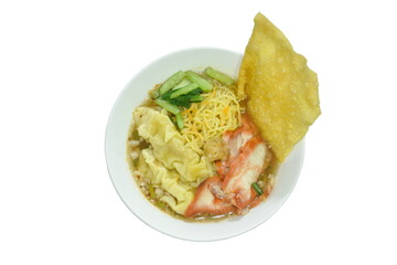 Chinese egg yellow noodles and dumpling topping boiled red barbecue pork with cabbage in tom yum soup on bowl