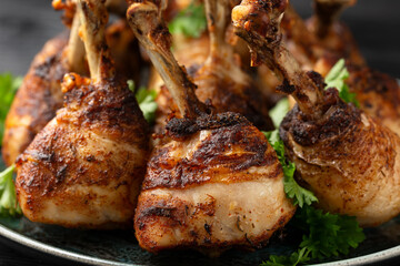 Roasted Chicken drumsticks lollipops on rustic plate
