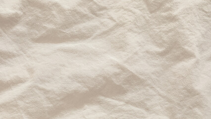 Close-Up View of a Textured White Fabric Surface Under Soft Lighting
