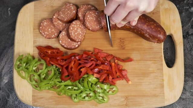 Slicing Turkish Sausage Also Known as Sucuk in Pan. Cutting Meat to Roast. Preparing for Breakfast Close Up Shot Slow Motion.