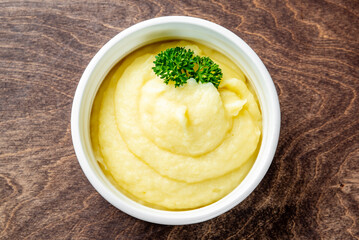 Fresh creamy mashed potato in white bowl on table