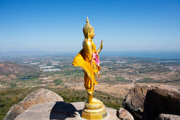 Buddha on cliff of Khao Phraya Doen Thong mountain for thai people travelers travel visit trail trekking go to respect praying blessing wish holy mystery at Phatthana Nikhom city in Lop Buri, Thailand - obrazy, fototapety, plakaty