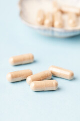 Coenzyme Q10 capsules. Dietary supplements. Bright paper background. Close up.	