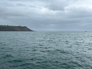 Plymouth sound sea on a grey winters day with sailing yacht in the United Kingdom. 