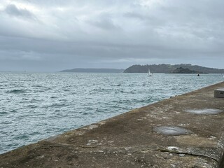 Plymouth sound sea on a grey winters day with sailing yacht in the United Kingdom. 