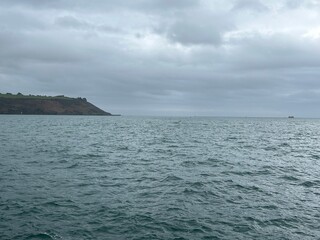 Plymouth sound sea on a grey winters day with sailing yacht in the United Kingdom. 