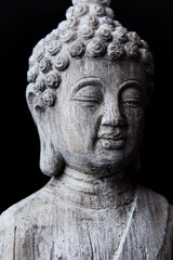 Obraz premium Meditating Buddha Statue on dark background. Soft focus. Close up. Copy space. 
