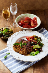 Grilled pork steak with fresh salad. Close up.