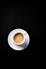 Cup of coffee on black background. Copy space.