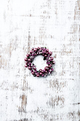 Christmas Wreath on bright wooden background. Top view. Copy space.	