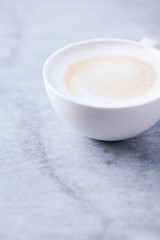 Cup of Coffee on bright stone background. Close up.	