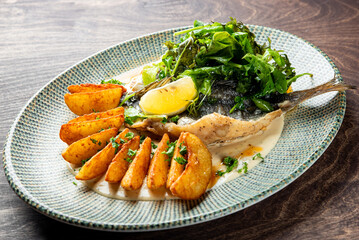 Fried dorado fish with Potato country style fried  and sauce on plate
