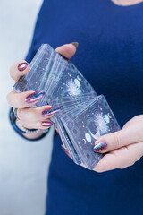 Female hands holding tarot cards for fortune telling and tricks
