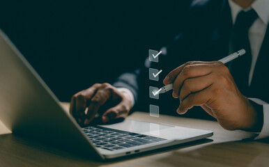 Businessman using pen and laptop online check survey filling out, digital form checklist...