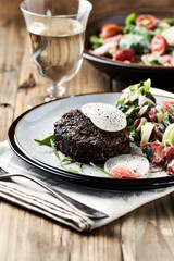 Fried hamburger steak with fresh salad. Wooden background. Close up.	