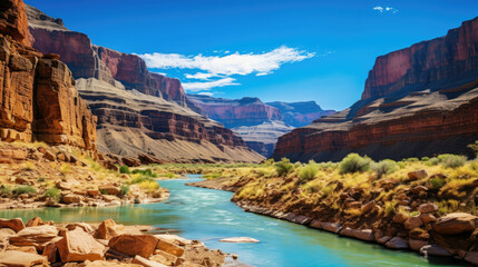 Scenic view of Grand Canyon with river and cliffs in sunny desert environment for tourism and adventure in Southwestern USA