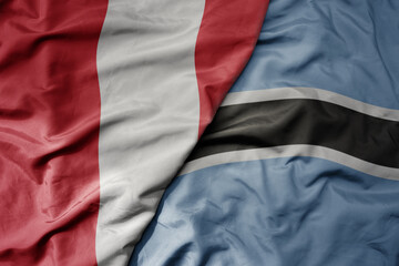 big waving national colorful flag of botswana and national flag of peru .