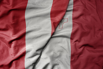 big waving national colorful flag of malta and national flag of peru .
