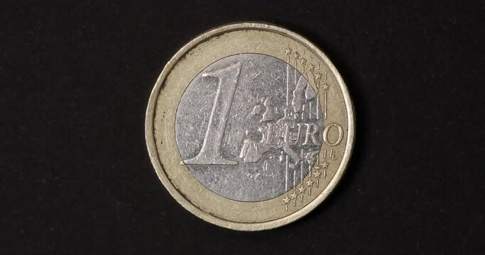 Used one Euro coins of different age changing on dark background. Big closeup of changing coins. Money, Cash, Timelapse, Finance concept. 4K stop motion animation.