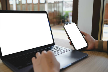 A white blank screen for hand typing text,using laptop and mobile phone contact business searching...