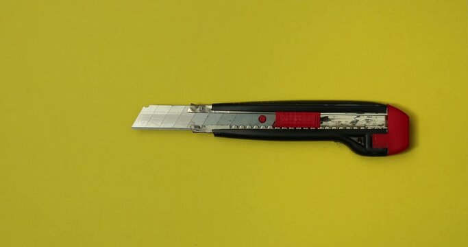 Cutter in action on color background. Loopable stop motion animation. 4K top view. DIY video concept. 
