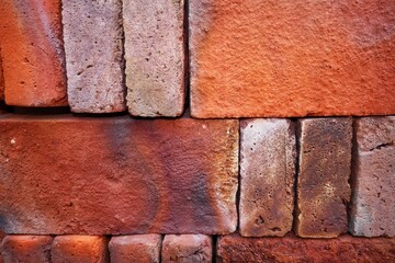 The texture of stacked red bricks
